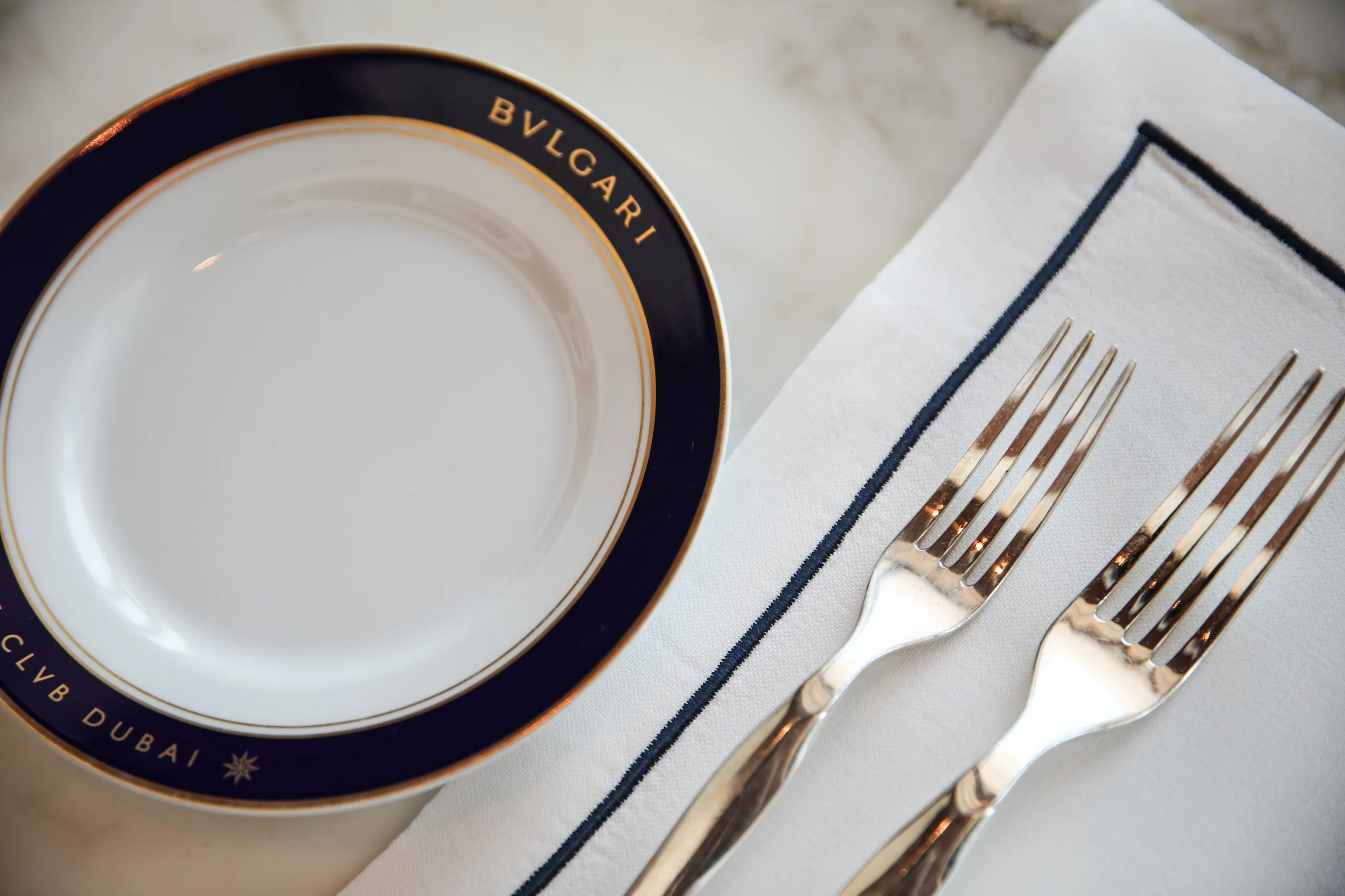 Bvlgari Dubai plate and gold cutlery, table detail