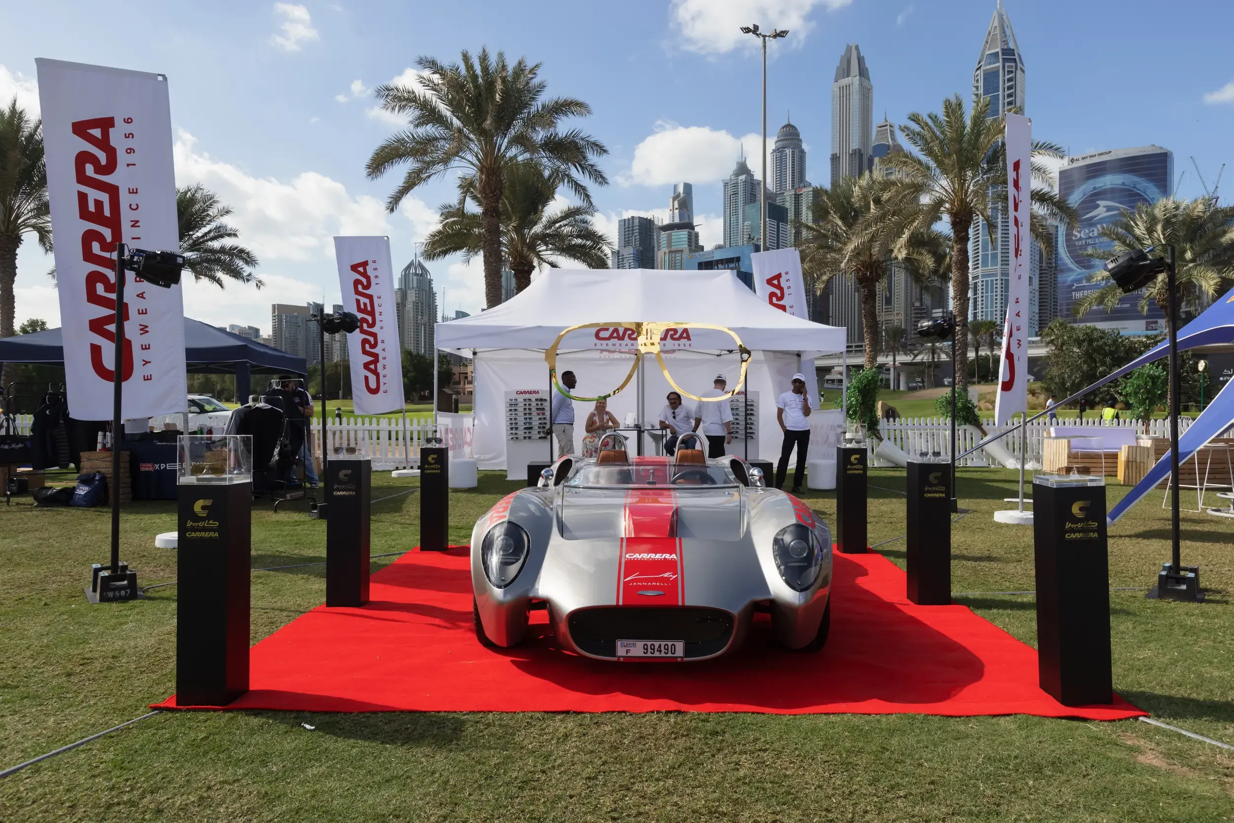 Carrera Eyewear outdoor activation with silver sports car, gold sunglasses sculpture and Dubai Marina skyline