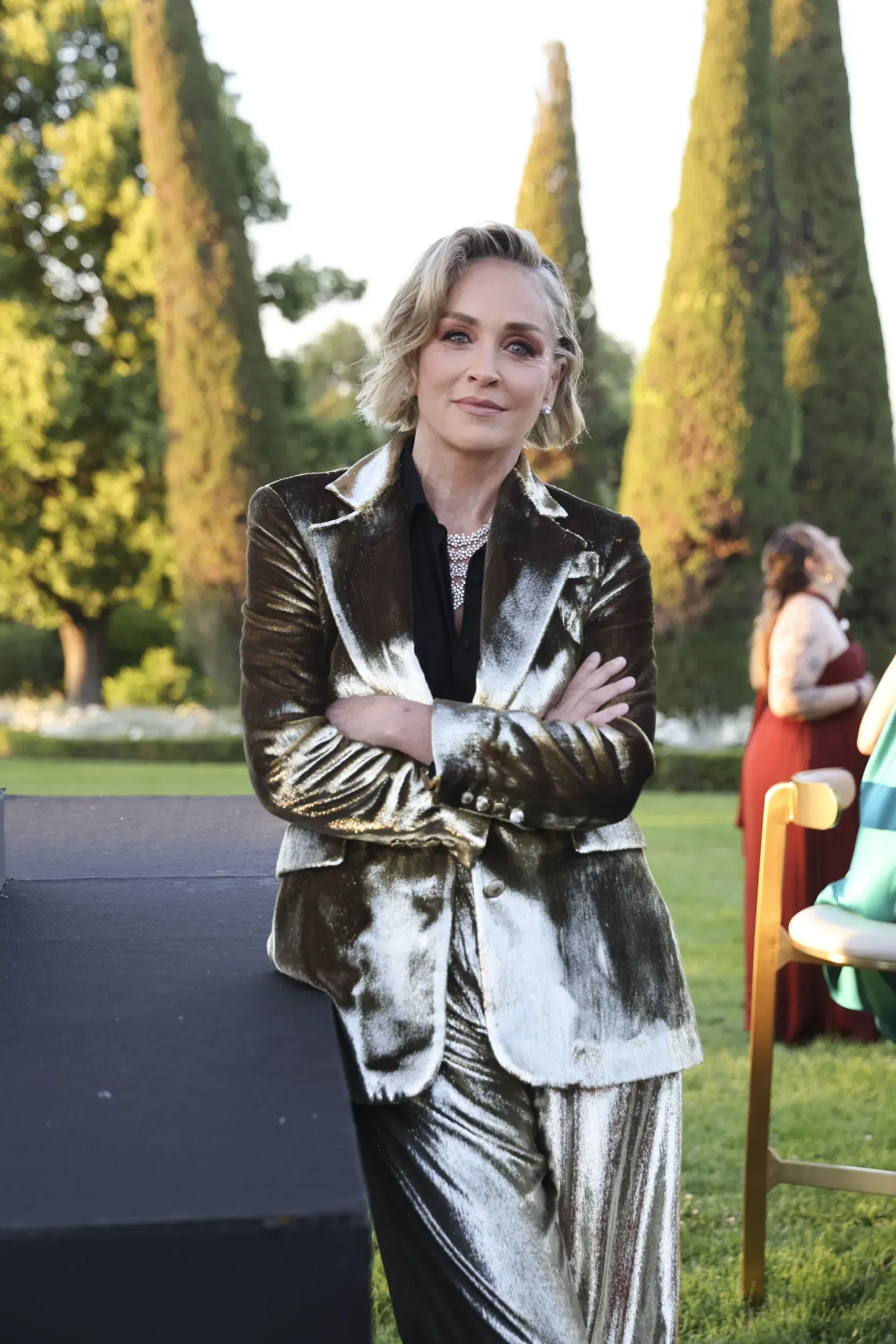 Sharon Stone in a gold suit, golden-hour portrait