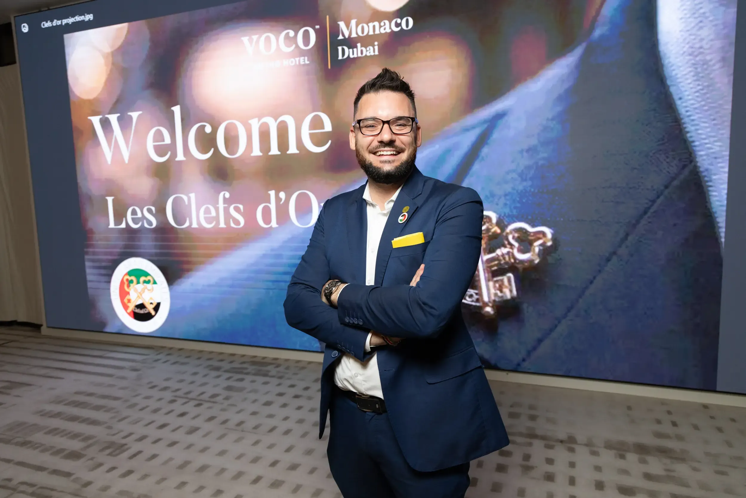 Guest speaker portrait at Les Clefs d'Or / VOCO Monaco Dubai event with crossed-keys branding