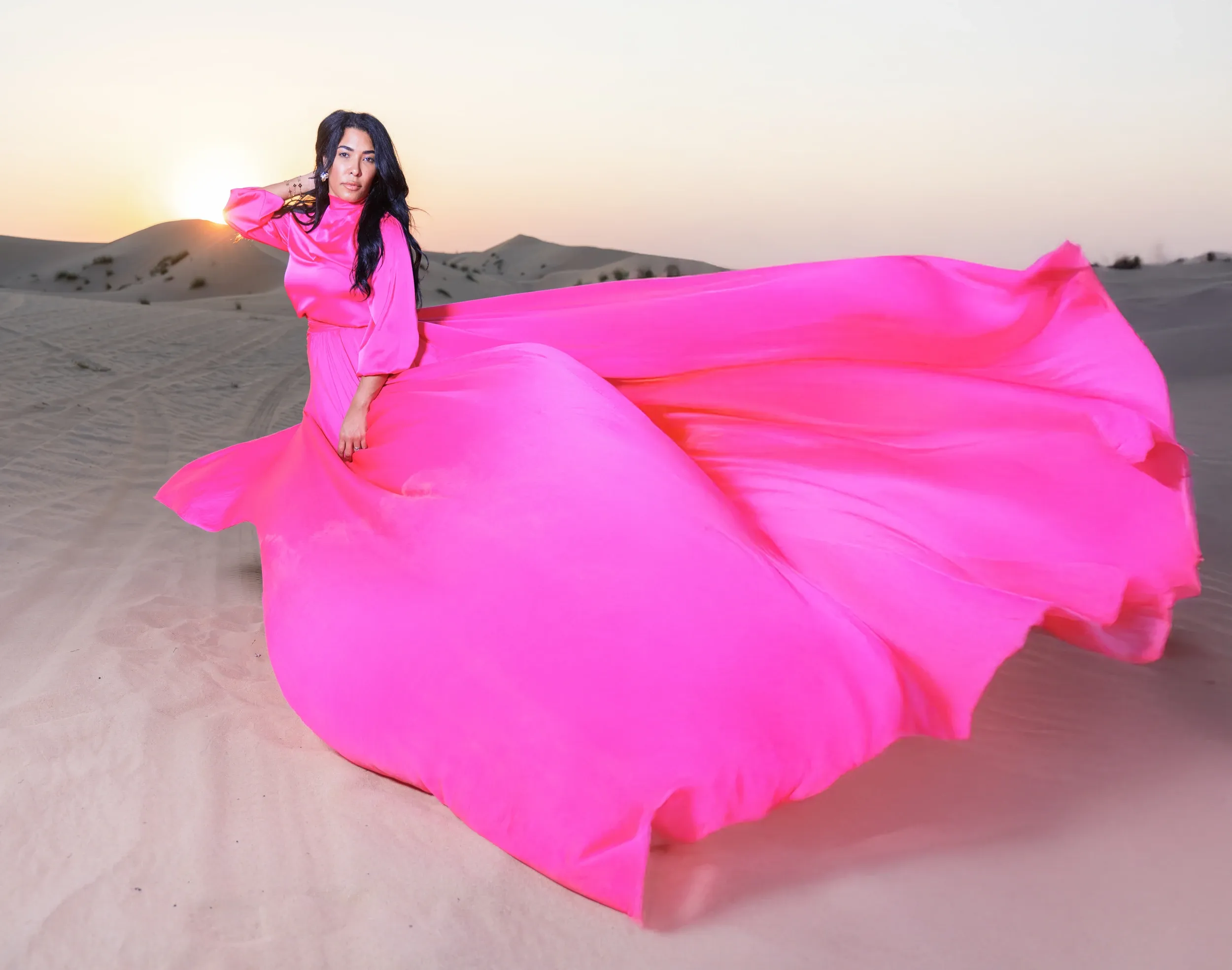 Pink flying dress spread on dunes
