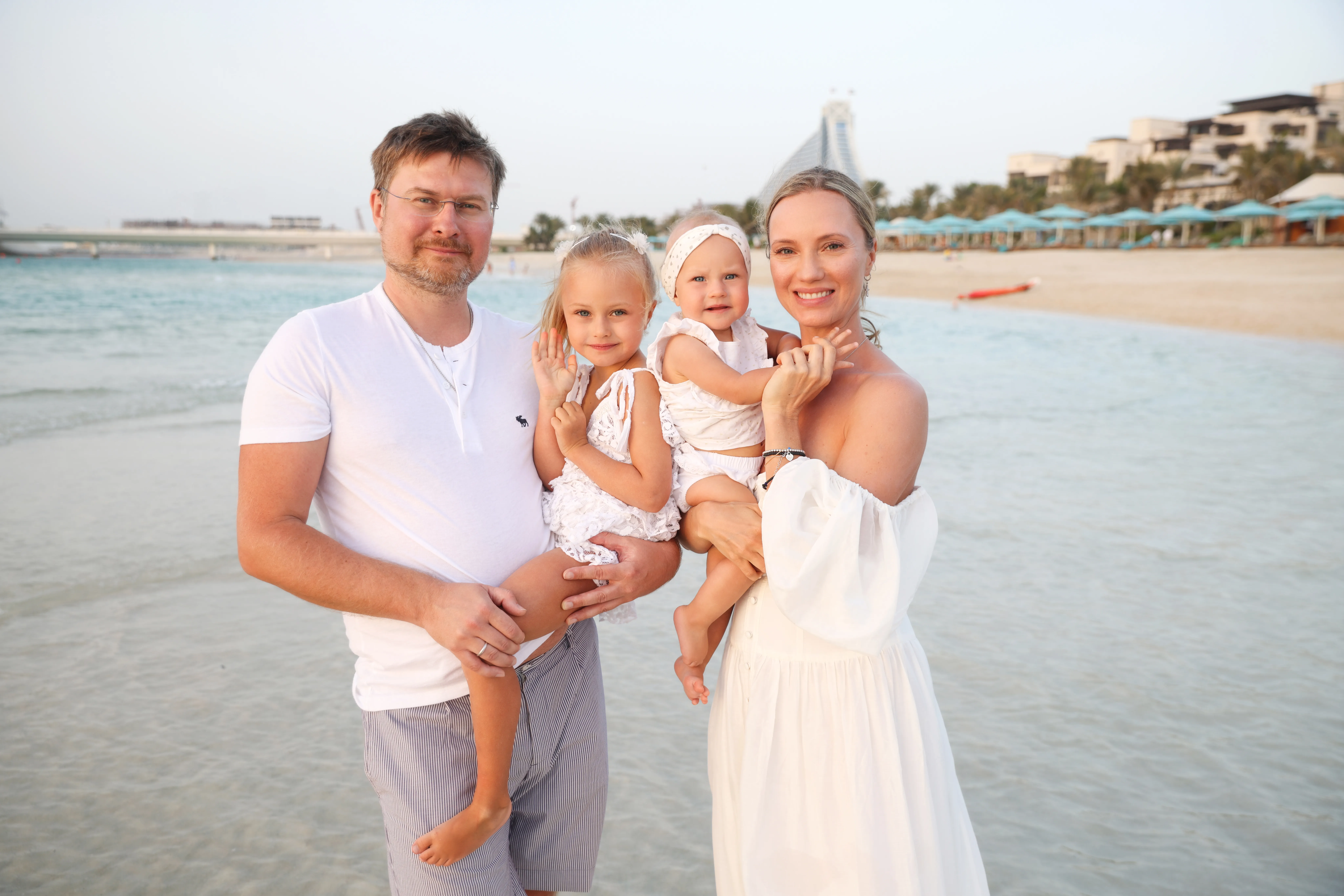 Family of four with twins on beach