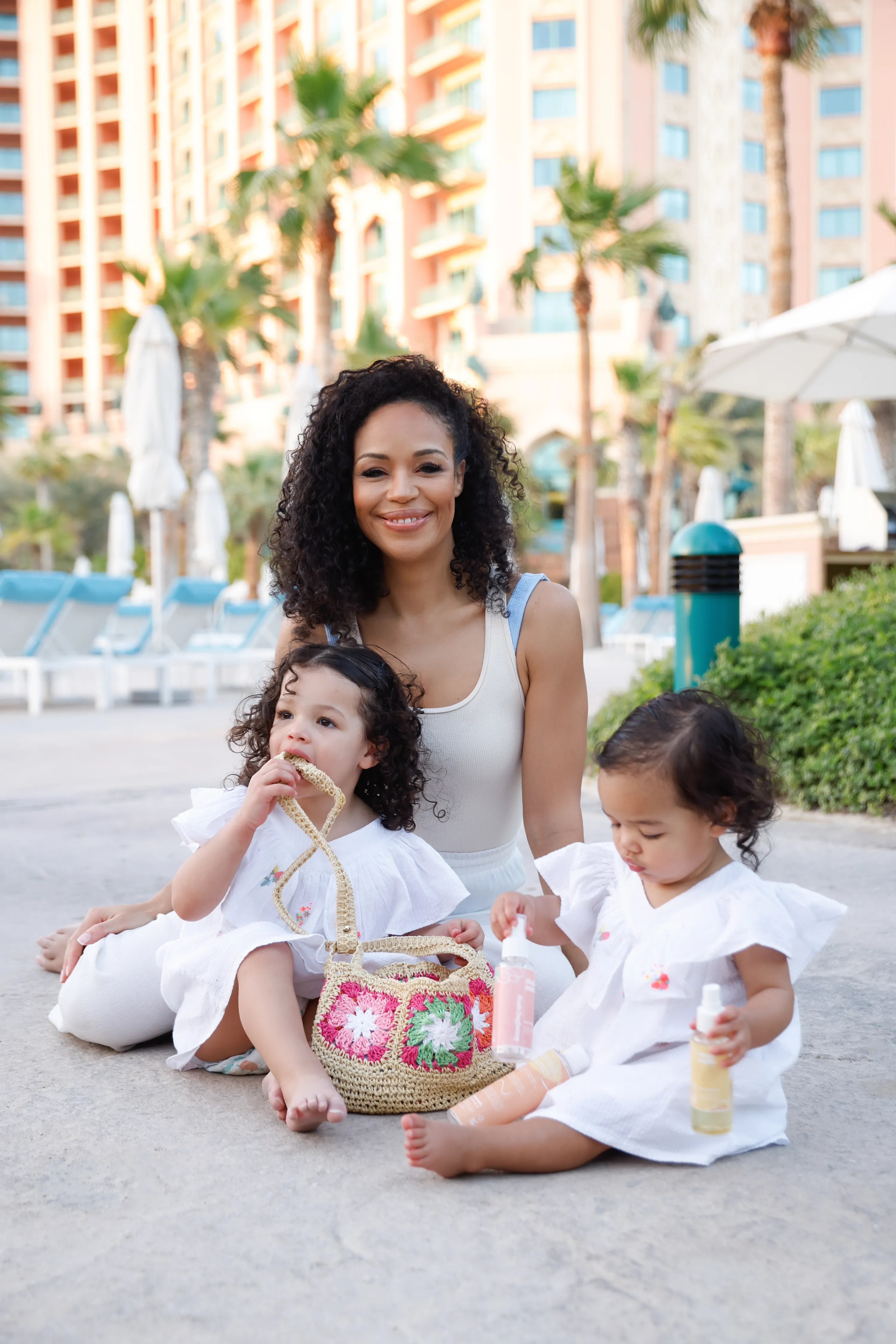 Mother with two toddlers by resort pool