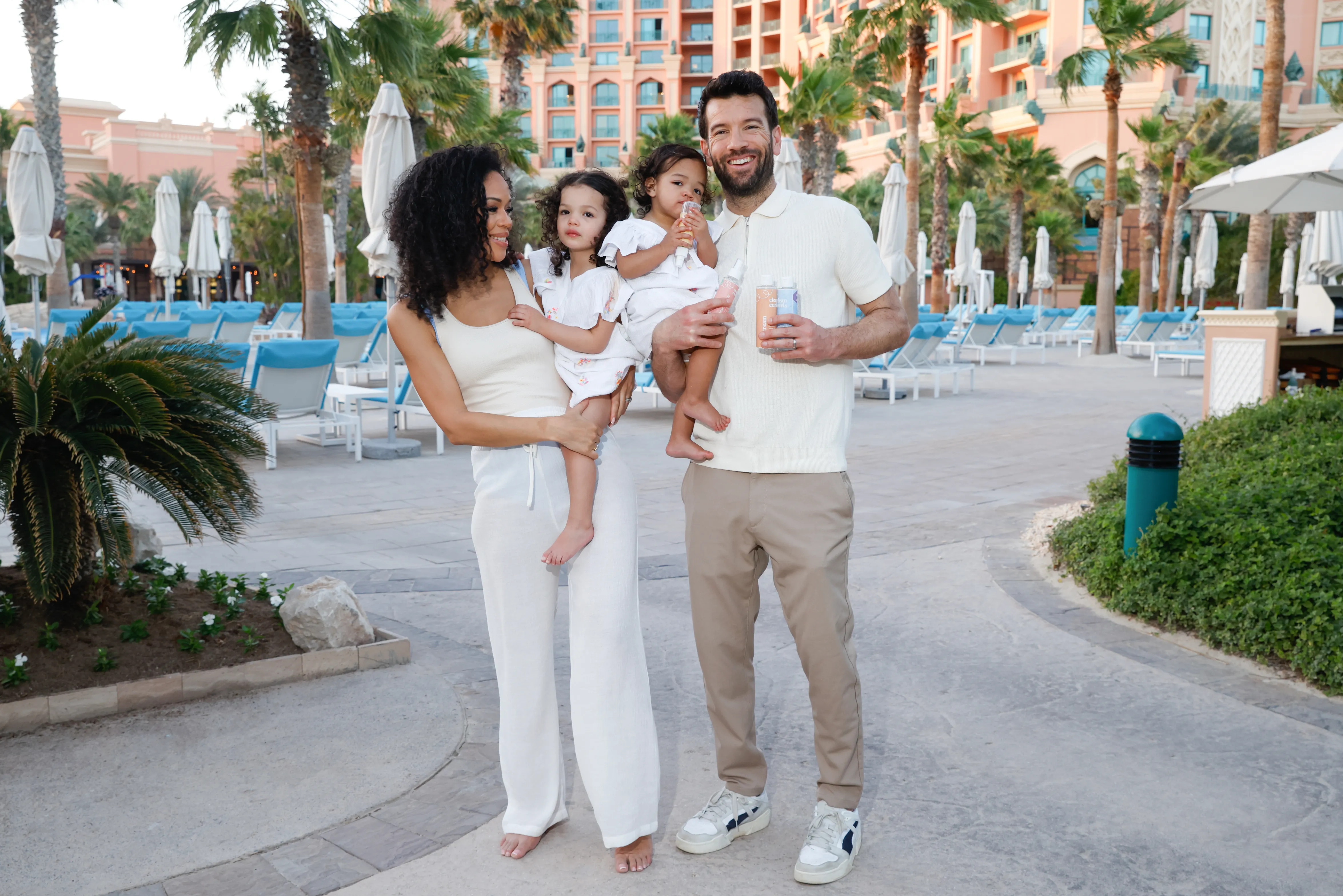 Young family with toddlers in resort garden