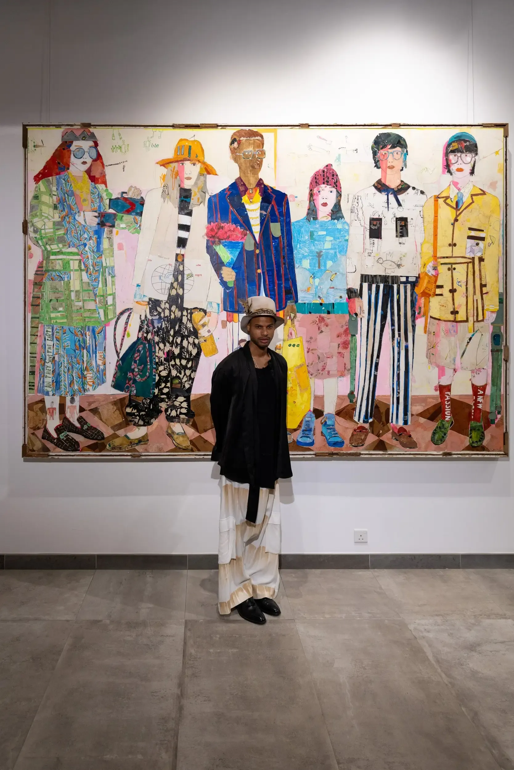A visitor standing beneath a large colourful figurative painting.