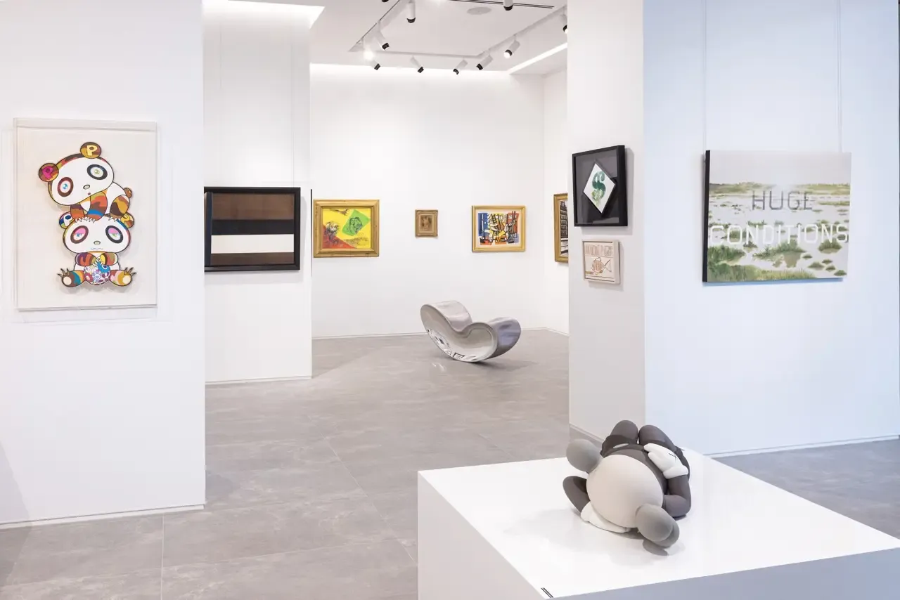 White-cube gallery install featuring KAWS and Murakami works