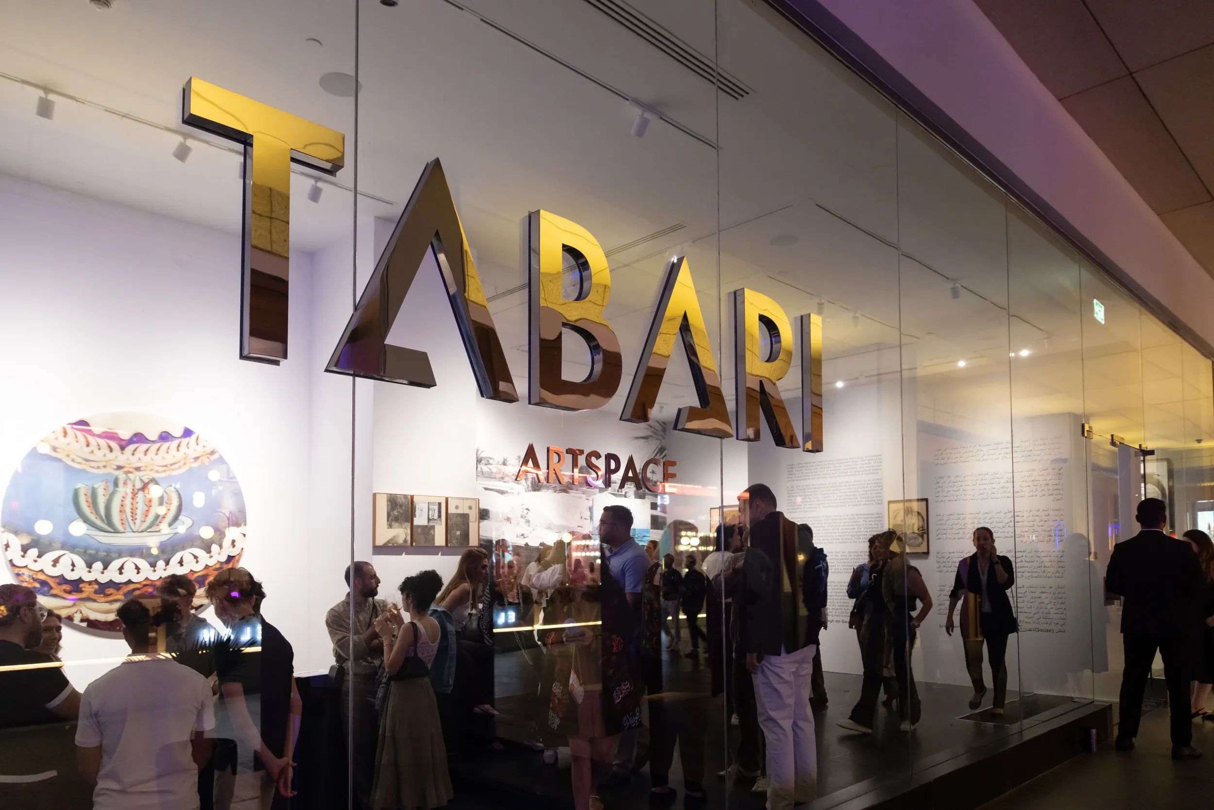 Guests visible through the glass frontage beneath TABARI ARTSPACE signage.